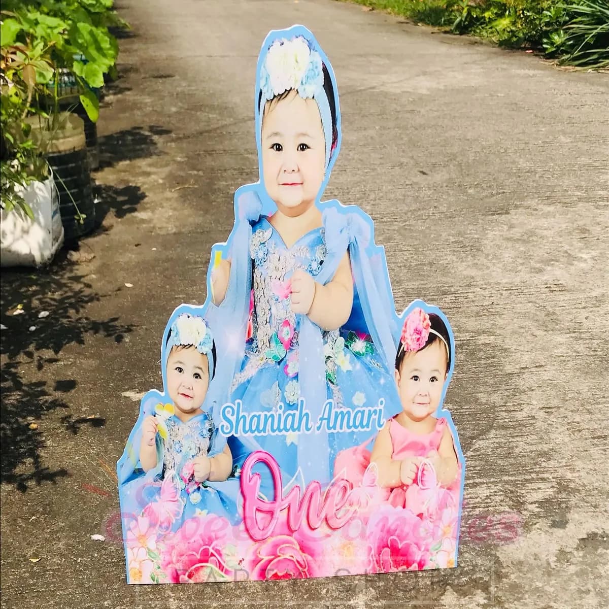 Lifesize christening standee of a baby in a white gown