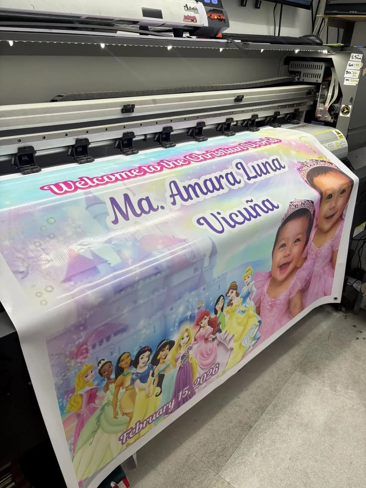 Personalized birthday tarpaulin coming out of the large-format printer